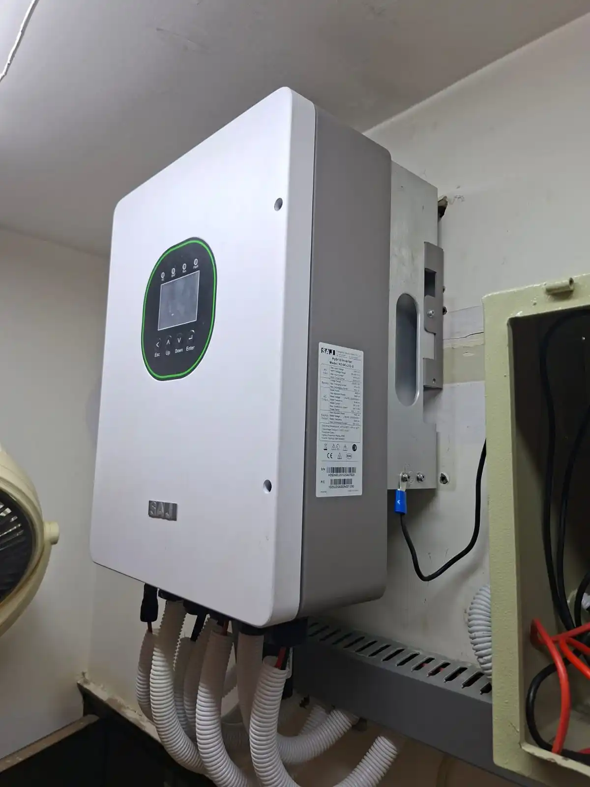 SAJ H2-6K hybrid inverter rating label showing 6kW output, installed during an on-grid to hybrid conversion in Karachi